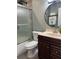 Bathroom featuring a glass door shower and a modern vanity with a stylish round mirror at 5826 Peregrine Ave # F01, Orlando, FL 32819