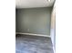 Bedroom with gray laminate flooring and a painted green wall, freshly renovated at 5826 Peregrine Ave # F01, Orlando, FL 32819