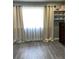 Bright bedroom with stylish window treatments and gray laminate flooring at 5826 Peregrine Ave # F01, Orlando, FL 32819