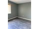 Bedroom with hardwood floors, window, and gray walls for a contemporary look at 5826 Peregrine Ave # F01, Orlando, FL 32819
