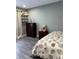 Cozy bedroom showcasing gray laminate flooring and calming pastel walls at 5826 Peregrine Ave # F01, Orlando, FL 32819