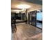 Dining area showcasing sliding glass doors, modern lighting, and a mirror wall adding depth to the space at 5826 Peregrine Ave # F01, Orlando, FL 32819