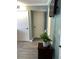 Entryway featuring gray floors, a white door, and a table with a plant accent at 5826 Peregrine Ave # F01, Orlando, FL 32819