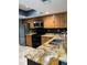 Modern kitchen featuring stainless steel appliances, wood cabinets, and stylish granite countertops for cooking at 5826 Peregrine Ave # F01, Orlando, FL 32819