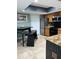 Well-lit kitchen with stainless steel appliances, granite countertops, and tiled flooring, ready for cooking at 5826 Peregrine Ave # F01, Orlando, FL 32819
