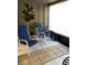 Enclosed patio featuring tile flooring, lawn chairs, and sun shade at 5826 Peregrine Ave # F01, Orlando, FL 32819