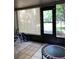 Enclosed patio featuring tile flooring, a door to the exterior, and a shade at 5826 Peregrine Ave # F01, Orlando, FL 32819