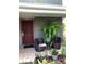 Cozy patio area featuring wicker seating, potted plants, and a welcoming entrance with seasonal decorations at 5826 Peregrine Ave # F01, Orlando, FL 32819
