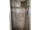 Close-up of a tiled shower stall with a built-in shelf and mosaic accents at 5826 Peregrine Ave # F01, Orlando, FL 32819