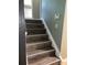 Staircase with wood-look steps and white risers leading to the next level of the home at 5826 Peregrine Ave # F01, Orlando, FL 32819