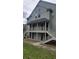 Two-story building featuring covered balconies and exterior staircases, set against a partly cloudy sky at 6148 Westgate Dr # 302, Orlando, FL 32835