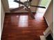 Hardwood floors and natural light fill a well-lit living space featuring a ceiling fan at 6148 Westgate Dr # 302, Orlando, FL 32835