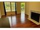 Well-lit living room with hardwood floors, fireplace and large windows that offer outside views at 6148 Westgate Dr # 302, Orlando, FL 32835