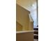 A well-lit carpeted staircase ascends, featuring bright walls and white trim at 6148 Westgate Dr # 302, Orlando, FL 32835
