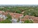 An aerial view of townhomes surrounded by green trees in a residential neighborhood at 7667 Sugar Bend Dr # 7667, Orlando, FL 32819