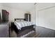 This bedroom features dark wood floors, an inviting bed, a dresser, and a bright white closet and trim at 7667 Sugar Bend Dr # 7667, Orlando, FL 32819