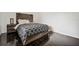 Cozy bedroom with rustic wood headboard and modern patterned bedding at 7667 Sugar Bend Dr # 7667, Orlando, FL 32819