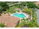 Aerial view of the large community pool with lounge chairs, landscaping and clubhouse at 7667 Sugar Bend Dr # 7667, Orlando, FL 32819