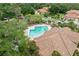Aerial view of community pool with ample lounge chairs, lush landscaping, and inviting atmosphere at 7667 Sugar Bend Dr # 7667, Orlando, FL 32819
