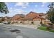 Row of townhomes featuring terra cotta color, tile roofs, and two car garages at 7667 Sugar Bend Dr # 7667, Orlando, FL 32819