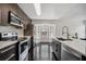 Modern kitchen with dark wood cabinets, stainless steel appliances, and a large bay window at 7667 Sugar Bend Dr # 7667, Orlando, FL 32819