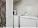 Bright laundry room with washer, dryer, and extra storage space at 7667 Sugar Bend Dr # 7667, Orlando, FL 32819