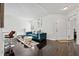 Modern living room with dark wood floors and stylish blue velvet sofa at 7667 Sugar Bend Dr # 7667, Orlando, FL 32819