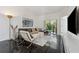 Comfortable living room with a stylish couch, a TV and access to the patio at 7667 Sugar Bend Dr # 7667, Orlando, FL 32819