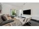 Bright living room with neutral decor and a view to the patio at 7667 Sugar Bend Dr # 7667, Orlando, FL 32819