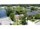 Scenic aerial view of a home backing onto a lake with mature trees and lush landscaping at 86 Blackberry Creek Dr, St Cloud, FL 34769