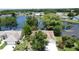 Beautiful aerial view of a home next to a tranquil pond with lush greenery and surrounding neighborhood at 86 Blackberry Creek Dr, St Cloud, FL 34769