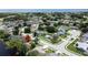 An aerial view shows lake access, mature trees and the neighborhood at 86 Blackberry Creek Dr, St Cloud, FL 34769