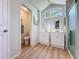 Bathroom featuring double vanities, separate toilet room, and a glass door shower at 86 Blackberry Creek Dr, St Cloud, FL 34769