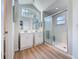 Bathroom featuring dual sinks, shower with glass doors, and neutral wall color at 86 Blackberry Creek Dr, St Cloud, FL 34769