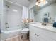 Clean bathroom featuring a shower-tub combo, a skylight, and a single sink vanity at 86 Blackberry Creek Dr, St Cloud, FL 34769