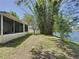The home's exterior shows the screened in patio that overlooks the picturesque lake at 86 Blackberry Creek Dr, St Cloud, FL 34769