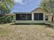 The exterior shows the back of the home, including the patio overlooking a manicured lawn at 86 Blackberry Creek Dr, St Cloud, FL 34769