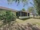 The exterior shows the expansive backyard along with a screened in patio and lush landscaping at 86 Blackberry Creek Dr, St Cloud, FL 34769
