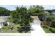 Lovely home with a manicured lawn, swaying palm tree, and lush green tree in front of the garage at 86 Blackberry Creek Dr, St Cloud, FL 34769