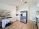 Bright kitchen features white cabinets, stainless steel refrigerator, and light wood flooring at 86 Blackberry Creek Dr, St Cloud, FL 34769
