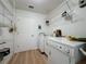 Practical laundry room with washer, dryer, wire shelving, and a utility sink at 86 Blackberry Creek Dr, St Cloud, FL 34769