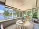Inviting enclosed patio with views of a serene lake surrounded by mature bamboo at 86 Blackberry Creek Dr, St Cloud, FL 34769
