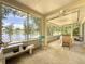 Relaxing screened patio with views of the lake, a ceiling fan, and furnishings at 86 Blackberry Creek Dr, St Cloud, FL 34769