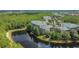Aerial view of a home surrounded by beautiful trees and a tranquil pond at 9055 Treasure Trove Ln # 207, Kissimmee, FL 34747