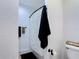 This bathroom features a textured wall, toilet, toilet paper, shower and black towel at 9055 Treasure Trove Ln # 207, Kissimmee, FL 34747
