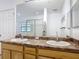 Primary bathroom with dual sinks, granite countertops, and a view to the walk-in shower at 9055 Treasure Trove Ln # 207, Kissimmee, FL 34747