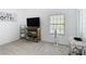 Bright spare bedroom with large TV, wall decor, and a neutral color scheme at 9055 Treasure Trove Ln # 207, Kissimmee, FL 34747