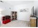 Spare bedroom with bright white walls, carpet floors, modern decor, and space for a tv and storage at 9055 Treasure Trove Ln # 207, Kissimmee, FL 34747