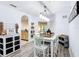 Dining area with modern light fixtures, wood look floors, and open access to the kitchen at 9055 Treasure Trove Ln # 207, Kissimmee, FL 34747