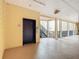 Hallway of building features tan walls, a black elevator door, nearby stairwell, and an exit sign at 9055 Treasure Trove Ln # 207, Kissimmee, FL 34747